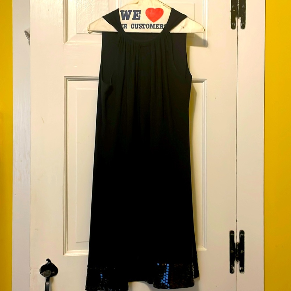 Sexy fun little black dress with sparkly hem. Loose fitting. EUC.
